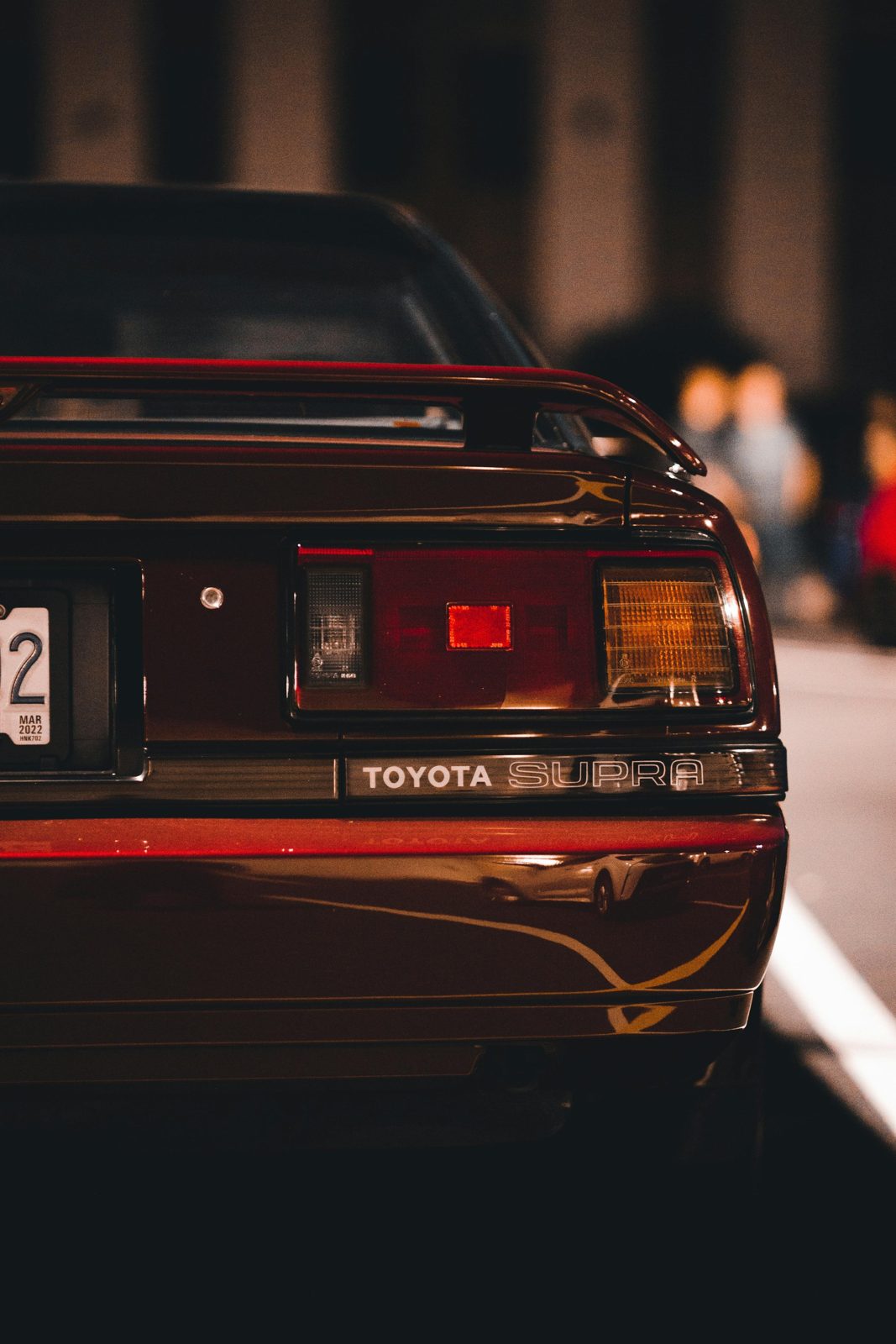 Rear view of a red Toyota Supra representing an eligible Japanese import